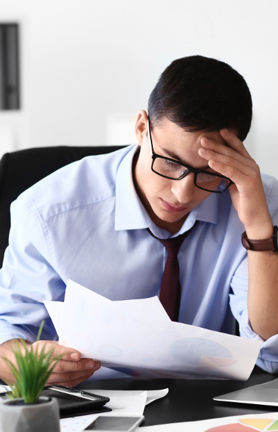 Stressed young businessman in office